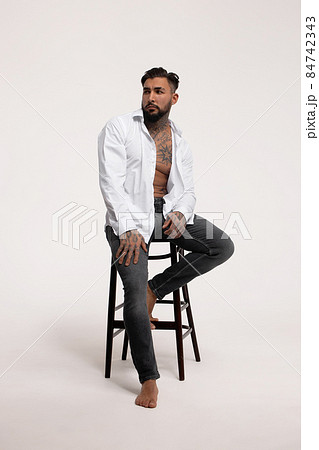 Muscular shirtless tattooed guy in studio Muscular shirtless tattooed guy in studio 84742343