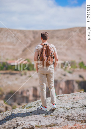 Young man on the edge of canyon in Cappodocia 84742351