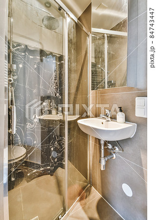 Interior design of an elegant bathroom with shower tall 84743447