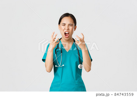 Covid-19, healthcare workers and preventing virus concept. Angry pissed-off asian female nurse, doctor losing temper, stressed-out physician shouting in anger, looking mad and aggressive Covid-19, healthcare workers and preventing virus concept. Angry pissed-off asian female nurse, doctor losing temper, stressed-out physician shouting in anger, looking mad and aggressive 84743559