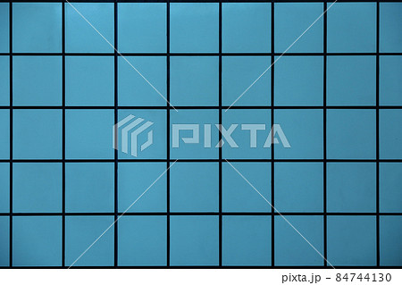 背景素材としての幾何学模様の水色のタイルの壁の写真素材