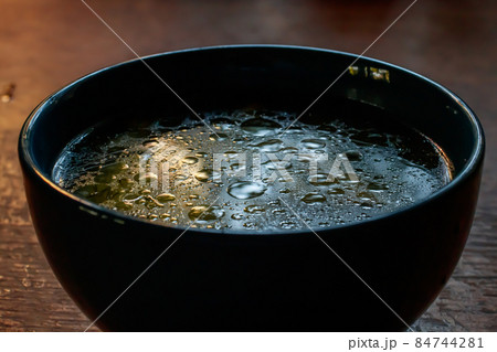 close up details of oil on water texture in blue soup bowl close up details of oil on water texture in blue soup bowl 84744281