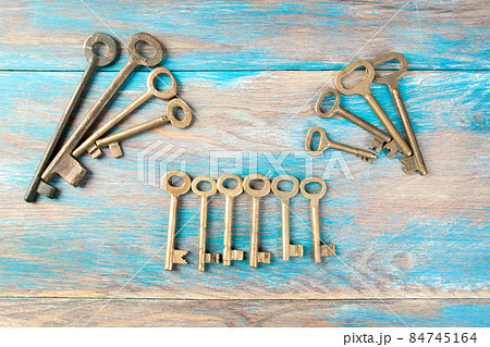 Old meal keys on wooden background 84745164