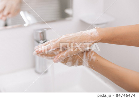 Washing hands under the flowing water tap. Washing hands rubbing with soap for corona virus prevention, hygiene to stop spreading corona virus in or public wash room. Hygiene concept hand detail. Washing hands under the flowing water tap. Washing hands rubbing with soap for corona virus prevention, hygiene to stop spreading corona virus in or public wash room. Hygiene concept hand detail. 84746474