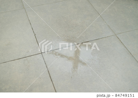 Water drips onto the tiled floor. Water drips onto the tiled floor. 84749151