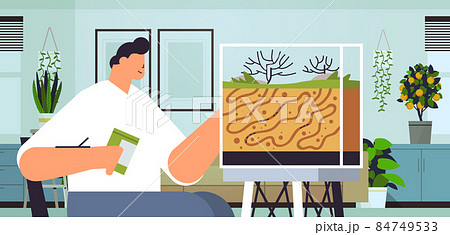 young man taking care of ant farm guy feeding ants in formicarium domestic insects concept living room interior 84749533