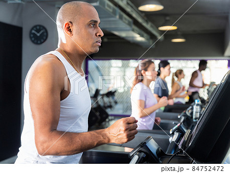 Man training on treadmill at fitness center Man training on treadmill at fitness center 84752472