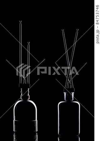 Still life with glass objects and metal antenna on a black background 84753746