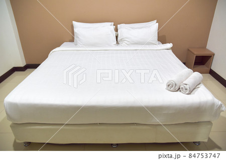 White single bed set and pillows and blankets of resort or hotel room, white room and free space in picture. 84753747