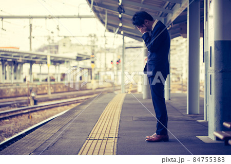 駅のホームで落ち込む男性　train 84755383