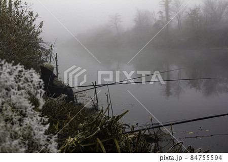 Autumn fishing on a foggy morning on a forest lake 84755594