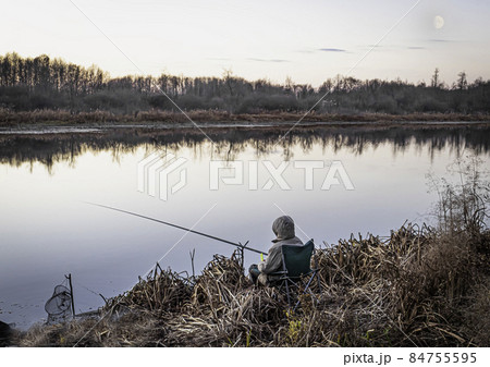 Autumn fishing on a forest lake at dawn Autumn fishing on a forest lake at dawn 84755595