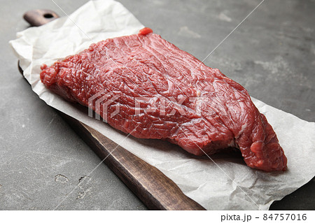 Fresh raw beef cut on grey table, closeup Fresh raw beef cut on grey table, closeup 84757016