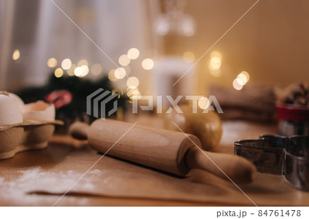 Polling pin for making gingerbread. Close-up of rolling raw dough for gingerbread. Christmas mood. Preparing for hollidays 84761478
