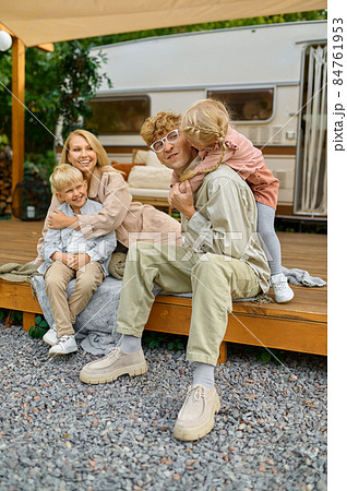 Happy family poses at the trailer, summer camping Happy family poses at the trailer, summer camping 84761953