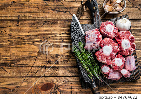 Raw beef Oxtail cut Meat on wooden cutting board with knife. wooden background. Top view. Copy space Raw beef Oxtail cut Meat on wooden cutting board with knife. wooden background. Top view. Copy space 84764622