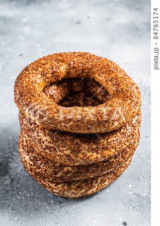 Turkish Bagel Simit with sesame traditional pastry. Gray background. Top view Turkish Bagel Simit with sesame traditional pastry. Gray background. Top view 84765174