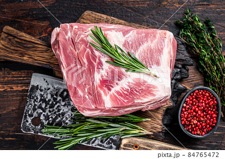 Pork neck raw meat for fresh Chop steaks on wooden cutting board with butcher cleaver. Dark wooden background. Top view Pork neck raw meat for fresh Chop steaks on wooden cutting board with butcher cleaver. Dark wooden background. Top view 84765472