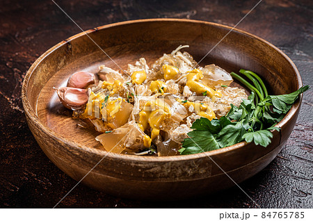 Aspic with chicken meat in plate with mustard. Dark background. Top view 84765785