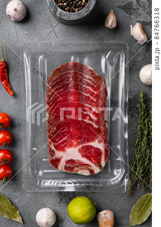 Cured meat coppa pack, on gray stone table background, top view flat lay 84766318