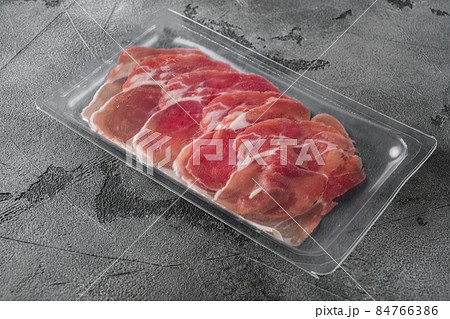 Cured ham jamon vacuum plastic pack, on gray stone table background, with copy space for text Cured ham jamon vacuum plastic pack, on gray stone table background, with copy space for text 84766386