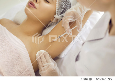 Doctor gives injection in underarm area to reduce armpit sweating, treat hyperhidrosis, prevent bad smell and body odor. Professional injecting glutathione to whiten skin color hyperpigmentation Doctor gives injection in underarm area to reduce armpit sweating, treat hyperhidrosis, prevent bad smell and body odor. Professional injecting glutathione to whiten skin color hyperpigmentation 84767195
