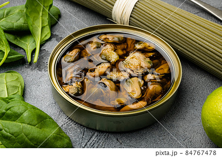 Opened cans conserve with mussels, on gray stone table background Opened cans conserve with mussels, on gray stone table background 84767478