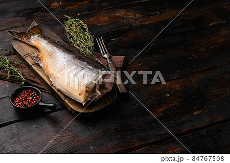 Smoked whole trout, on old dark wooden table background, with copy space for text 84767508