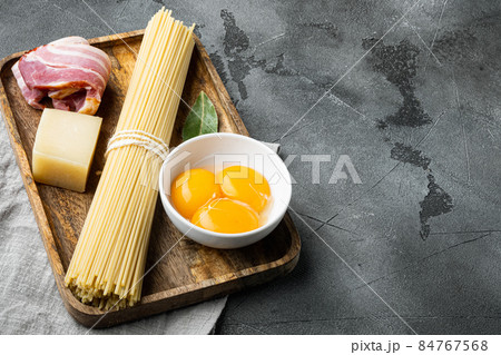 Carbonara pasta ingredients, on gray stone background, with copy space for text Carbonara pasta ingredients, on gray stone background, with copy space for text 84767568