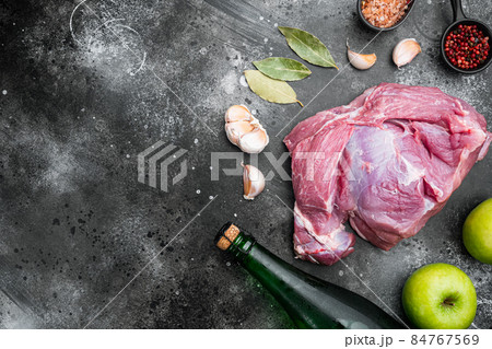 Raw pork cutlet with oil and spices for grill or cooking, with apple dry cider, on black dark stone table background, top view flat lay, with copy space for text Raw pork cutlet with oil and spices for grill or cooking, with apple dry cider, on black dark stone table background, top view flat lay, with copy space for text 84767569