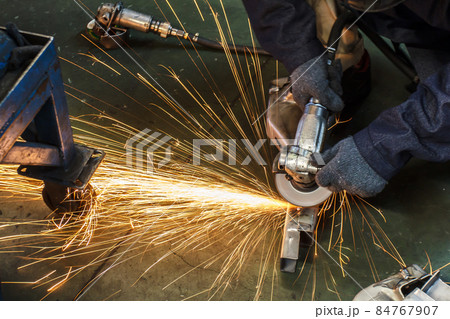 Metal in a factory grinding with sparks Metal in a factory grinding with sparks 84767907