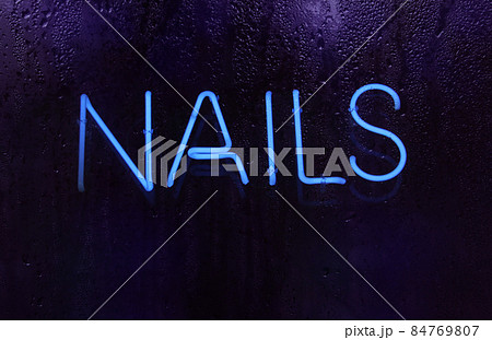 Blue Neon Nail Sign in Salon Window Blue Neon Nail Sign in Salon Window 84769807