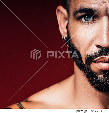 Handsome blue-eyed Cuban or Latino with beard looks straight into camera. Part of face of man 30-40 Handsome blue-eyed Cuban or Latino with beard looks straight into camera. Part of face of man 30-40 84772107