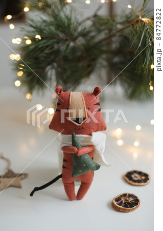 cute soft toy tiger with decorations on a cozy Christmas or New Year background. symbol of 2022, oriental calendar concept 84772822