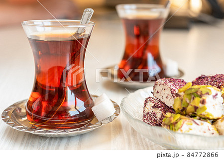 Traditional style turkish tea cup with turkish delay on the table Traditional style turkish tea cup with turkish delay on the table 84772866