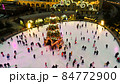 people skate on ice rink around christmas tree 84772900