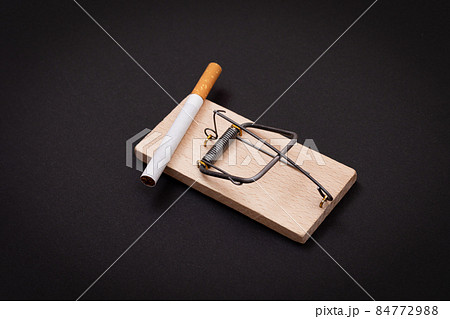 Tobacco Addiction - Cigarettes in Wooden Mousetrap Tobacco Addiction - Cigarettes in Wooden Mousetrap 84772988