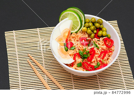 Beautiful Noodle Dish with Green Pea, Eggs, Red Hot Pepper, Greens and Lime Beautiful Noodle Dish with Green Pea, Eggs, Red Hot Pepper, Greens and Lime 84772996