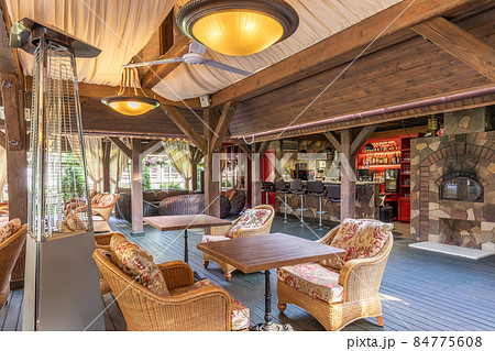 the interior of an outdoor summer cafe without visitors with a bar counter and rattan furniture the interior of an outdoor summer cafe without visitors with a bar counter and rattan furniture 84775608