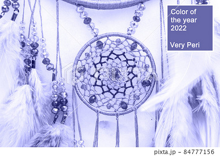 Handmade dream catcher with feathers threads and beads rope in very peri trendy color of the year 2022. Handmade dream catcher with feathers threads and beads rope in very peri trendy color of the year 2022. 84777156