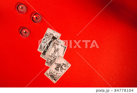 Tarot cards on red background, occult and magic 84778104