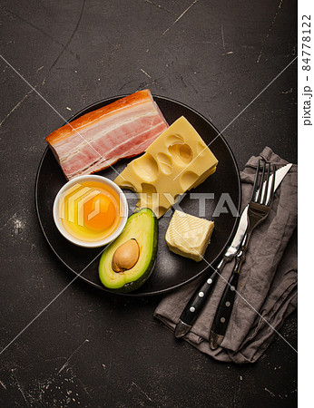 Foods for keto diet on black plate on dark background Foods for keto diet on black plate on dark background 84778122