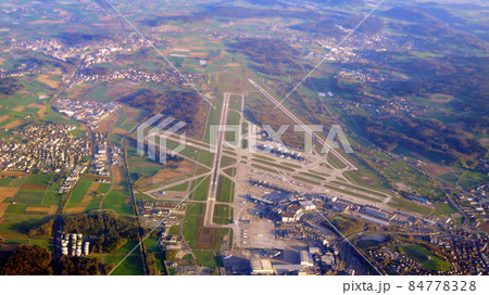 ZURICH, SWITZERLAND - 15th APRIL 2015: Aerial view of the multiple runways and terminals at Zurich international airport ZURICH, SWITZERLAND - 15th APRIL 2015: Aerial view of the multiple runways and terminals at Zurich international airport 84778328