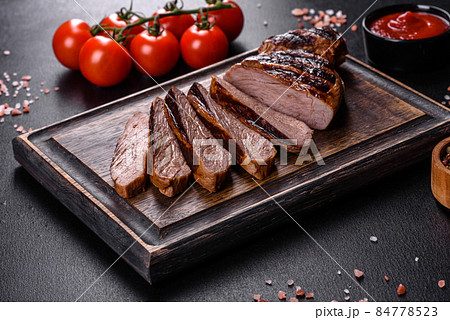 Cooked grilled Chuck eye roll steak on a chopping Board Cooked grilled Chuck eye roll steak on a chopping Board 84778523