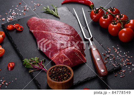 Raw fresh Chuck roll steak with herbs and salt on a cutting Board 84778549