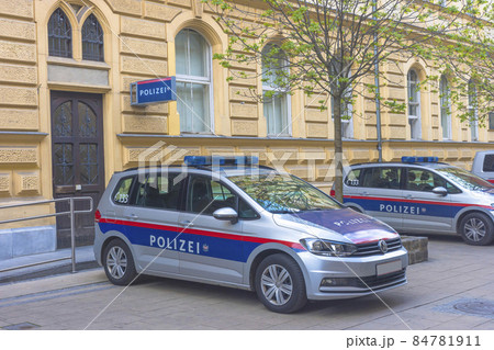Austrian federal police cars parked on the street in front of the police headquarters in the old city center of Graz, Austria 84781911