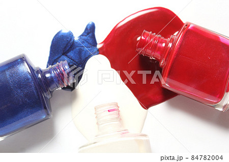 Red and Blue Spilled Nail Polish on White Background Red and Blue Spilled Nail Polish on White Background 84782004