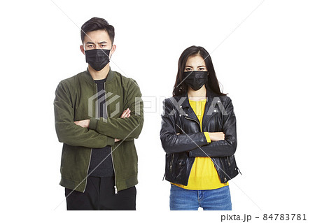 young asian man and woman wearing black mask looking at camera frowning isolated on white background young asian man and woman wearing black mask looking at camera frowning isolated on white background 84783781