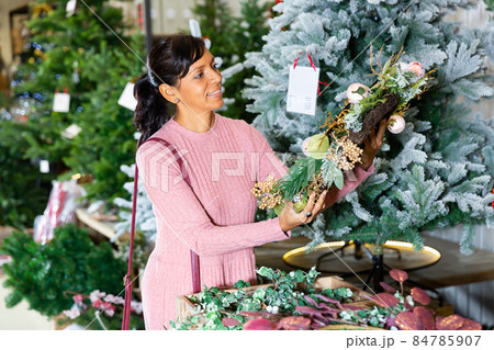 Latin woman choosing christmas decorations 84785907