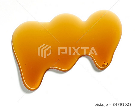 flowing sugar syrup on white background 84791023